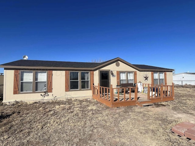 rear view of house featuring a deck