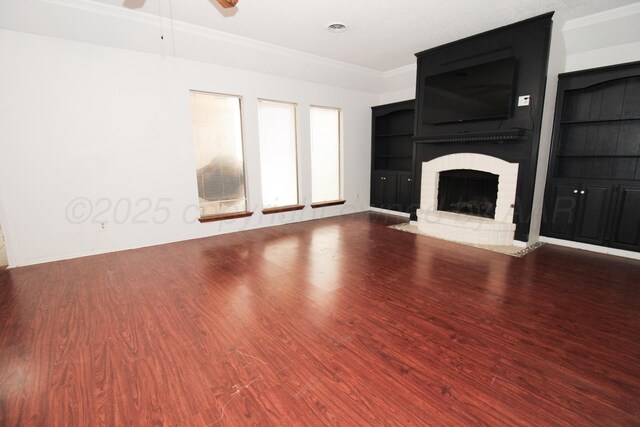 6108 Belpree Rd, Amarillo, TX 79106 - unfurnished living room featuring wood finished floors, a brick fireplace, ceiling fan, ornamental molding, and built in shelves