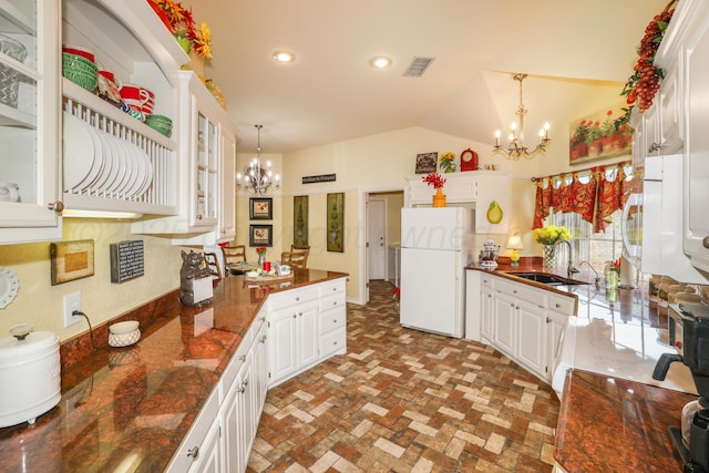 5809 Foxcroft Dr, Amarillo, TX 79109 - kitchen featuring a chandelier, white appliances, a sink, white cabinets, and lofted ceiling