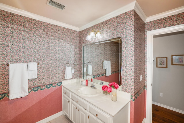 5809 Foxcroft Dr, Amarillo, TX 79109 - bathroom with crown molding, vanity, baseboards, and wood finished floors