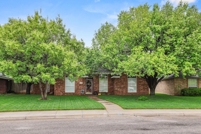 5809 Foxcroft Dr, Amarillo, TX 79109 - view of property hidden behind natural elements with a front yard and brick siding