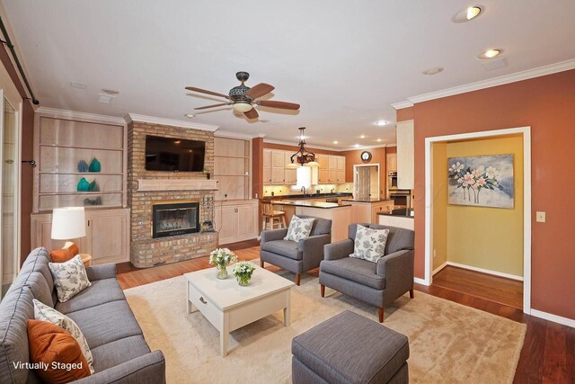 18 Didrickson Ln, Amarillo, TX 79124 - living area with a ceiling fan, wood finished floors, crown molding, a brick fireplace, and recessed lighting