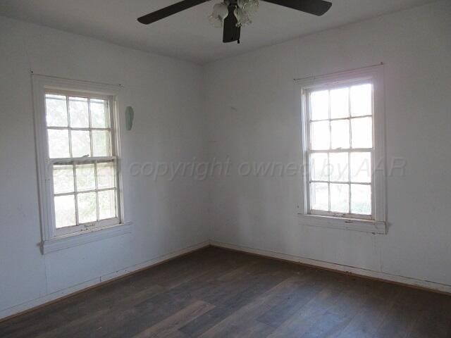 413 N Bowie Ave, Tulia, TX 79088 - empty room with ceiling fan, wood finished floors, and plenty of natural light