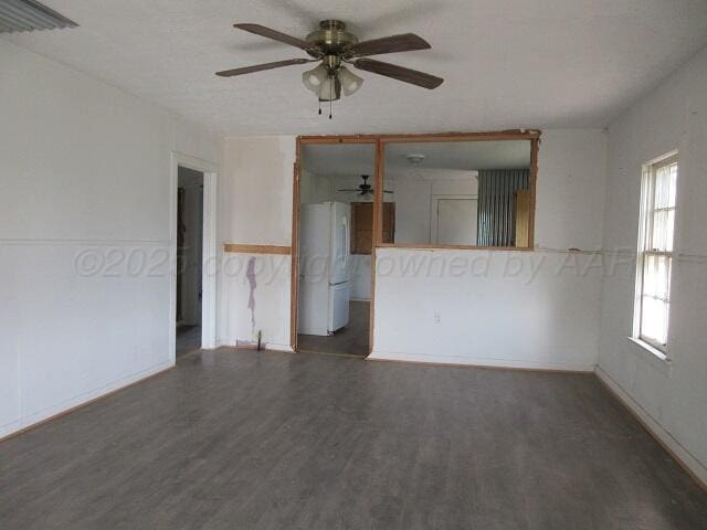 413 N Bowie Ave, Tulia, TX 79088 - unfurnished living room with ceiling fan and wood finished floors