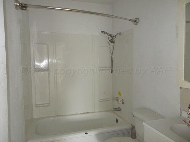 413 N Bowie Ave, Tulia, TX 79088 - bathroom with bathtub / shower combination and vanity