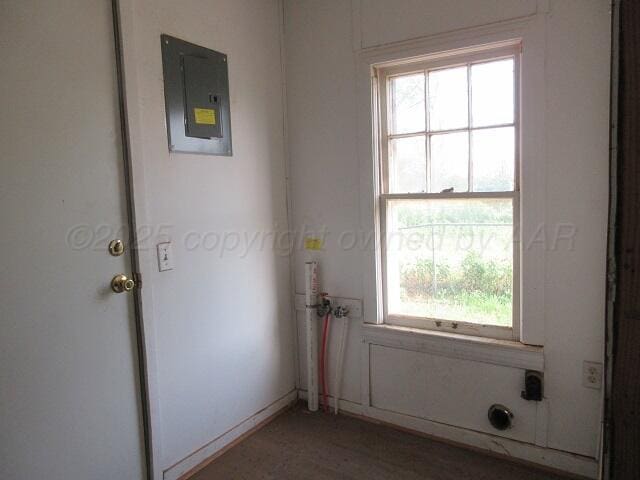 413 N Bowie Ave, Tulia, TX 79088 - doorway to outside featuring electric panel and healthy amount of natural light