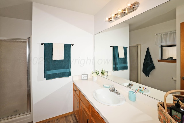 full bath featuring a shower stall, vanity, and wood finished floors