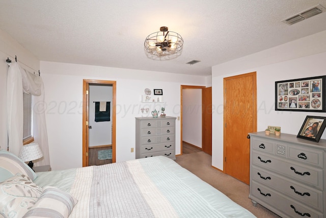 carpeted bedroom with a textured ceiling