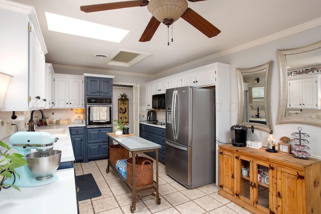 6010 Calumet Rd, Amarillo, TX 79106 - kitchen with black appliances, light countertops, blue cabinetry, a ceiling fan, and crown molding
