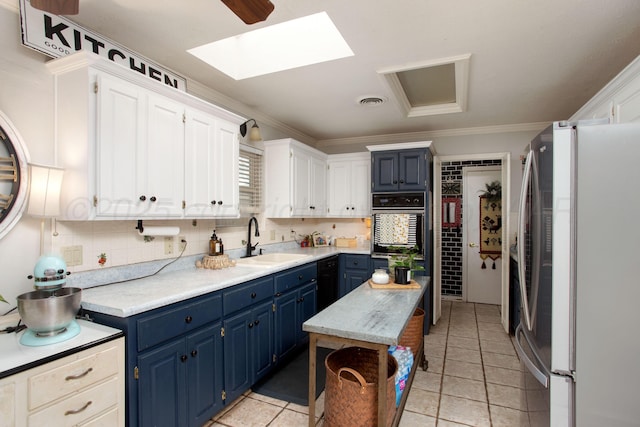 6010 Calumet Rd, Amarillo, TX 79106 - kitchen with freestanding refrigerator, blue cabinets, oven, light countertops, and ornamental molding