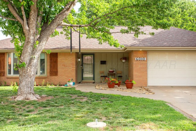 6010 Calumet Rd, Amarillo, TX 79106 - single story home with a shingled roof, a garage, driveway, and a front lawn