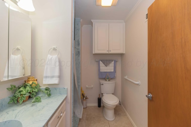 bathroom with tile patterned floors, toilet, vanity, and ornamental molding