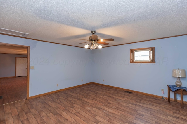 spare room featuring a textured ceiling, ceiling fan, wood-type flooring, and ornamental molding