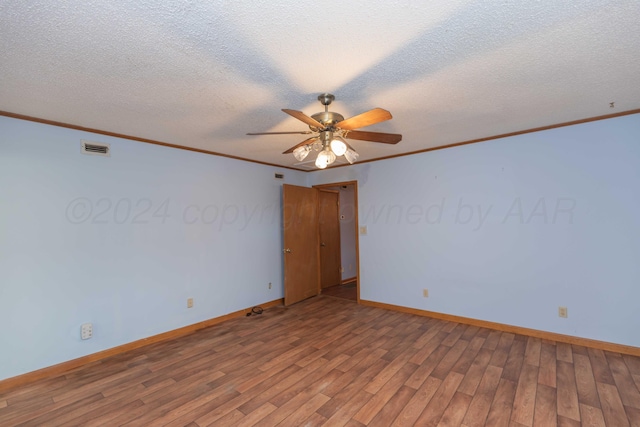 unfurnished room featuring wood-type flooring, a textured ceiling, ceiling fan, and ornamental molding