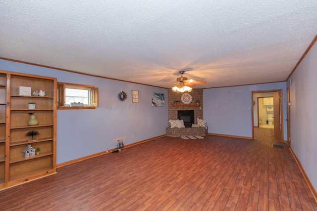 unfurnished living room featuring a textured ceiling, ceiling fan, a fireplace, and dark hardwood / wood-style floors