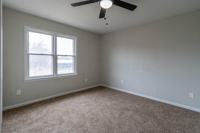 carpeted empty room featuring ceiling fan