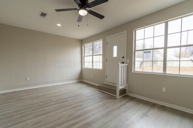 interior space with ceiling fan and light hardwood / wood-style flooring