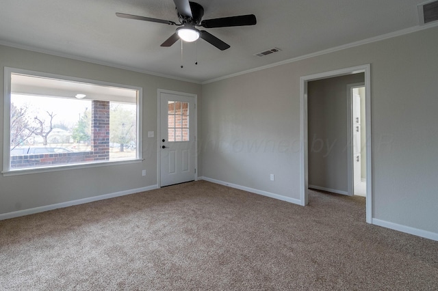 unfurnished room featuring crown molding, ceiling fan, and light colored carpet