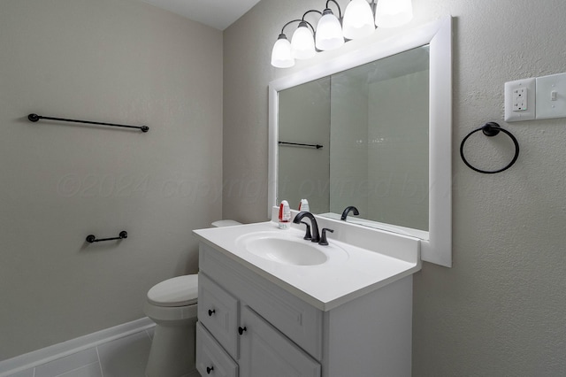 bathroom with tile patterned flooring, vanity, and toilet