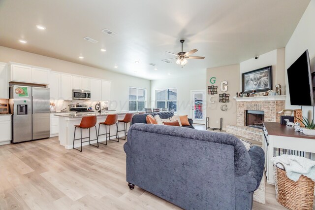 1706 Morningside Ave, Amarillo, TX 79118 - living room with ceiling fan, light wood-style flooring, a brick fireplace, and recessed lighting