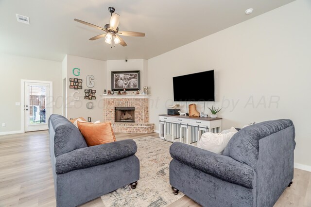 1706 Morningside Ave, Amarillo, TX 79118 - living room featuring light wood finished floors, a ceiling fan, and a fireplace