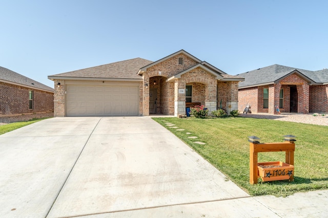 1706 Morningside Ave, Amarillo, TX 79118 - view of front facade featuring brick siding, driveway, an attached garage, a front yard, and a shingled roof