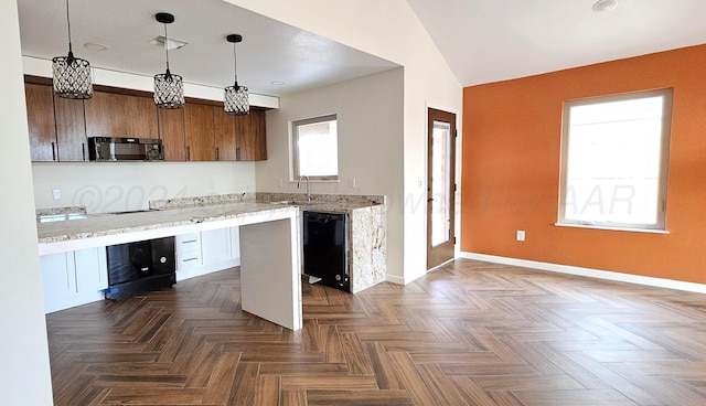 kitchen featuring pendant lighting, black appliances, dark parquet flooring, and lofted ceiling