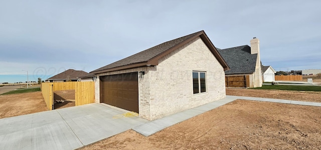 view of side of property with a garage