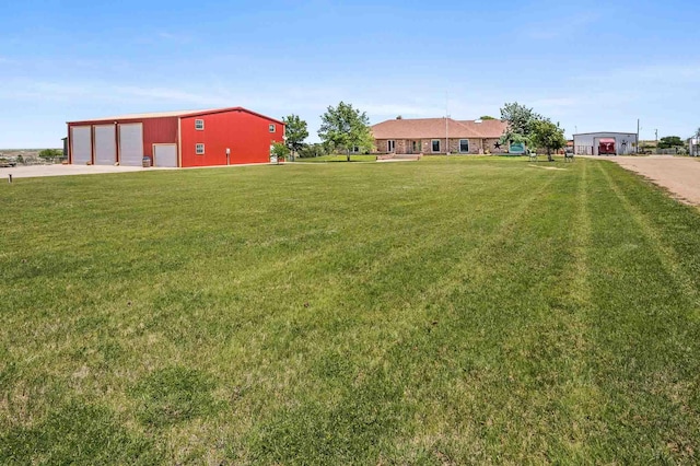 1513 S Girl Scout Rd, Amarillo, TX 79124 - view of grassy yard with a detached garage, an outbuilding, and a pole building