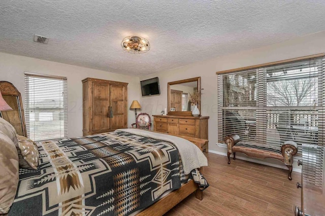 1513 S Girl Scout Rd, Amarillo, TX 79124 - bedroom featuring wood finished floors, baseboards, and a textured ceiling