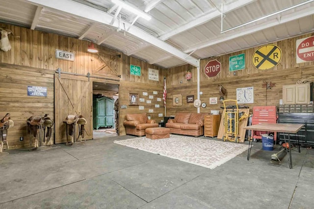 1513 S Girl Scout Rd, Amarillo, TX 79124 - miscellaneous room with concrete floors, wooden walls, and a barn door