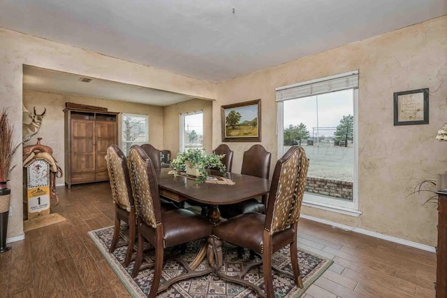 1513 S Girl Scout Rd, Amarillo, TX 79124 - dining space featuring dark wood-type flooring, baseboards, and a textured wall
