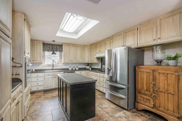 1513 S Girl Scout Rd, Amarillo, TX 79124 - kitchen with stainless steel appliances, a skylight, dark countertops, a center island, and light brown cabinets