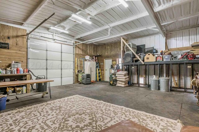1513 S Girl Scout Rd, Amarillo, TX 79124 - garage with wood walls, refrigerator, and metal wall