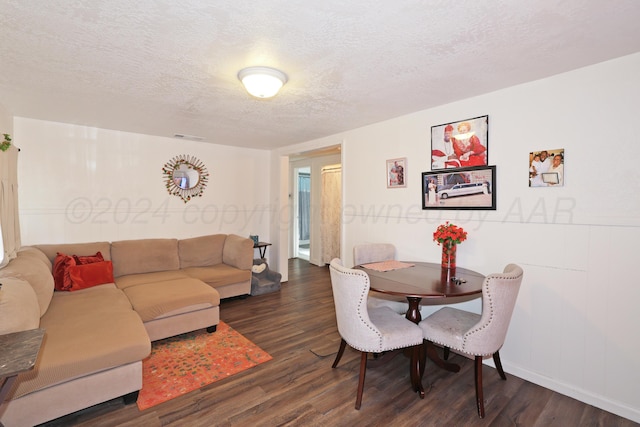 4112 S Monroe St, Amarillo, TX 79110 - dining space featuring dark wood-style flooring, a textured ceiling, and baseboards