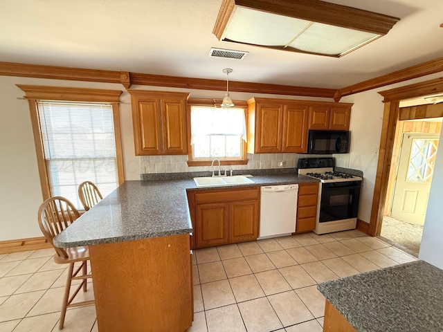 kitchen featuring visible vents, a sink, gas range oven, black microwave, and dishwasher