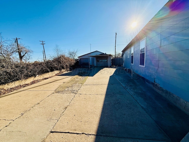 exterior space with a garage, an outbuilding, and driveway