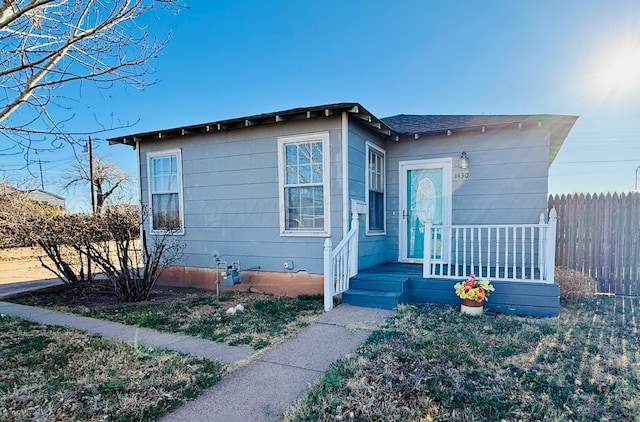 bungalow-style house with fence