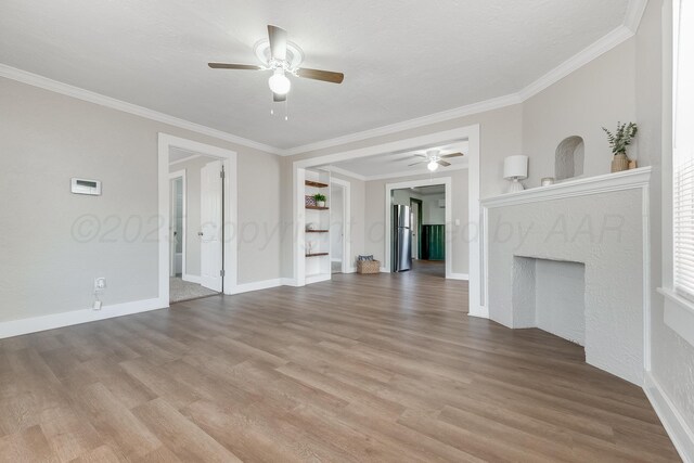 4818 Brown Ave, Amarillo, TX 79108 - unfurnished living room with a ceiling fan, wood finished floors, ornamental molding, baseboards, and a high end fireplace