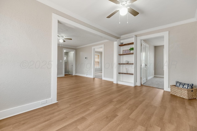 4818 Brown Ave, Amarillo, TX 79108 - unfurnished living room featuring a ceiling fan, crown molding, light wood-style flooring, baseboards, and built in features