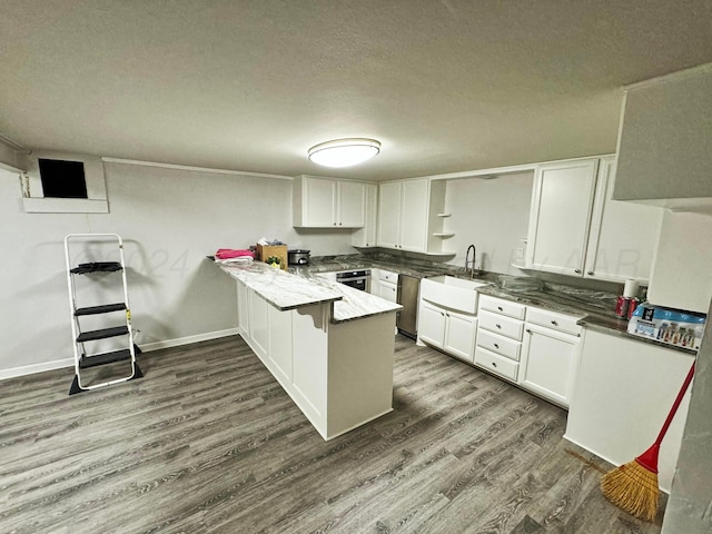 kitchen with white cabinetry, kitchen peninsula, sink, and dark hardwood / wood-style floors