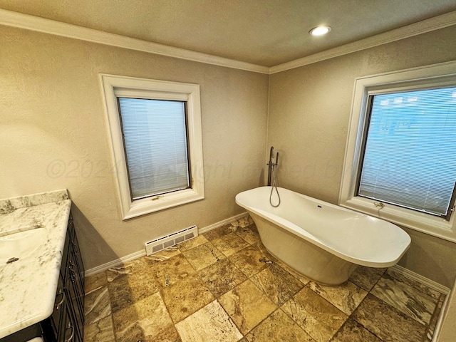 bathroom featuring a bathing tub, vanity, and crown molding