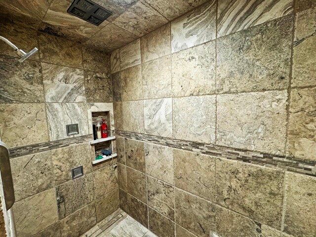 bathroom with tiled shower