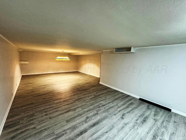 interior space with dark wood-type flooring and a textured ceiling