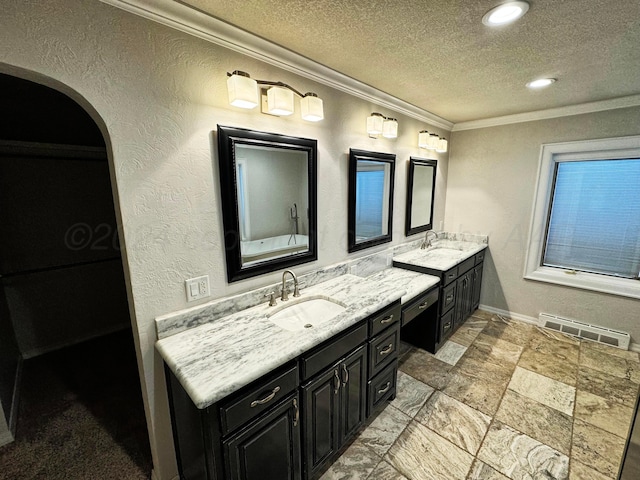 bathroom with ornamental molding, vanity, and a textured ceiling