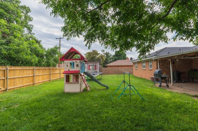 6102 Calumet Rd, Amarillo, TX 79106 - fenced backyard featuring a playground and a patio