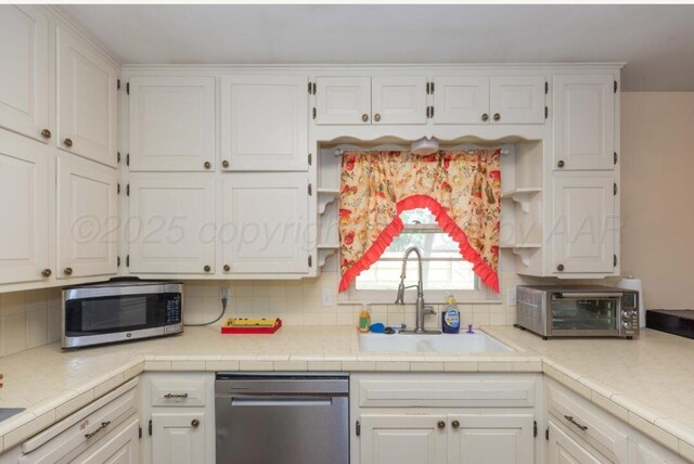 6102 Calumet Rd, Amarillo, TX 79106 - kitchen featuring stainless steel appliances and white cabinetry