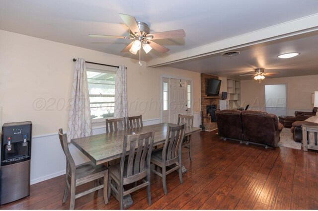 6102 Calumet Rd, Amarillo, TX 79106 - dining area featuring a ceiling fan, dark wood-style flooring, and a stone fireplace