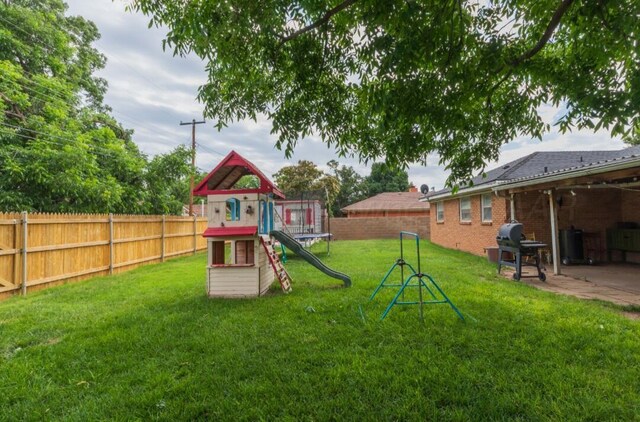 6102 Calumet Rd, Amarillo, TX 79106 - fenced backyard featuring a playground and a patio