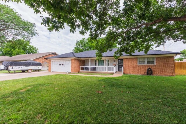 6102 Calumet Rd, Amarillo, TX 79106 - single story home with brick siding, concrete driveway, a garage, and covered porch